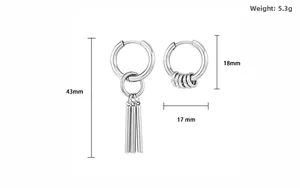 Macro detail of geometric silver steel drop earrings with technical size markings