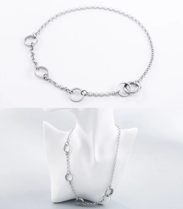 Minimalist stainless steel chain necklace with circular ring links on white mannequin
