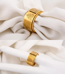 Detailed macro of gold rotating mantra ring featuring engraved Buddhist Heart Sutra