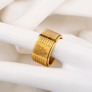 Golden titanium steel spinning ring with engraved Heart Sutra on white hand display