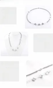 Détail macro du collier à billes en acier 316L et pendentifs dés avec poli miroir