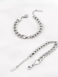 Detailed view of silver stainless steel NK curb chain and beaded link bracelet set