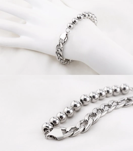 Detail of silver stainless steel NK curb and bead chain bracelet with lobster clasp