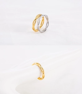 Macro detail of twisted rope rings in gold and silver finish with minimalist texture