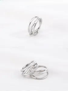 Macro detail of silver geometric criss cross stacked ring in minimalist punk style