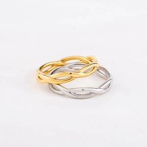 Minimalist twisted wave rings set in gold and silver finish with polished surface