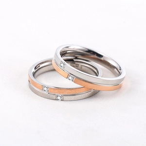 Minimalist silver and rose gold couple rings with diamond accents in titanium steel