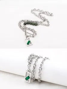 Detail of industrial punk double necklace with green square crystal pendant and chunky chain