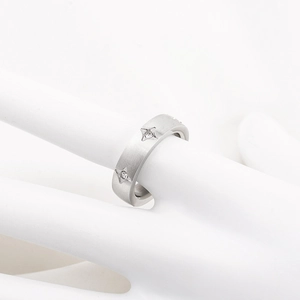 Minimalist silver steel ring with brushed finish and diamond four-pointed star engravings