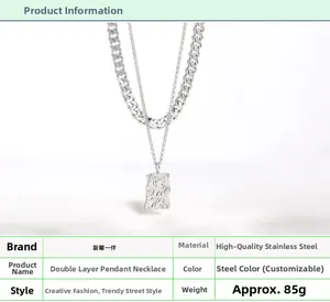Detail of double-layer stainless steel Cuban chain necklace with textured rectangular pendant