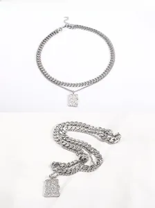 Detail of silver double-layer Cuban chain necklace with a textured rectangular pendant