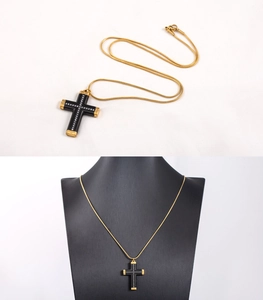 Close-up of hip hop gold cross necklace with black plating and white diamond inlay