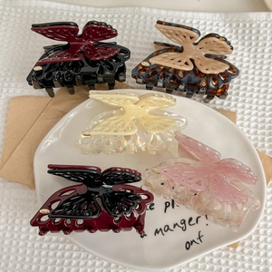 Elegant butterfly hair claws in acetate finish with diverse marble and tortoiseshell patterns