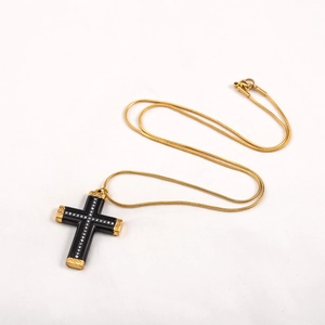 Hip hop black cross necklace with gold edges and small diamonds on a gold snake chain