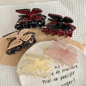 Elegant cutout butterfly hair claws in five colors including tortoiseshell and pearl white
