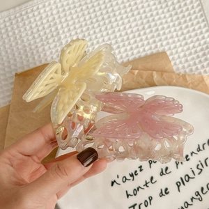 Elegant pearlized acetate butterfly hair claw clips in cream and pink marble finish