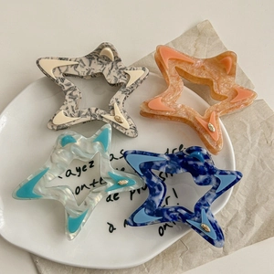 Star-shaped hollow hair claw clips in marble acetate patterns for women's hairstyling