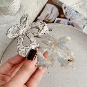 Minimalist marble butterfly hair claw clip in beige and blue acetic acid resin material