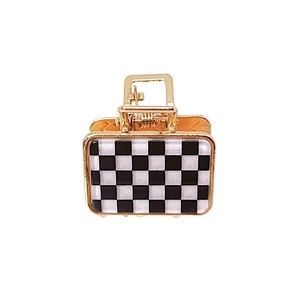 Golden checkerboard hair claw clip with black and white grid pattern for women
