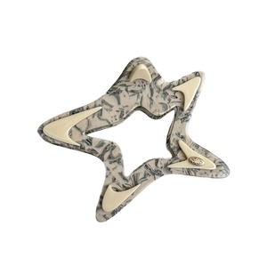 Star shaped hair claw in marble acetate with crescent accents and golden logo