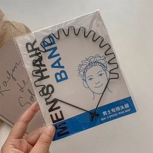 Detail of men's black wavy metal headband with packaging and instruction card