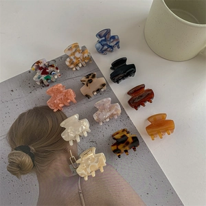 Elegant cellulose acetate mini hair claw clips in various marbled patterns and colors