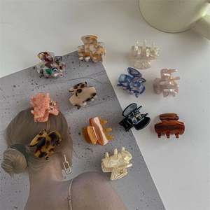 Elegant acetate hair claw clips in marble and leopard patterns for women's hair styling