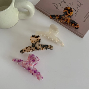 Set of 4 large acetate hair claws in tortoise shell, cream, leopard, and marble patterns