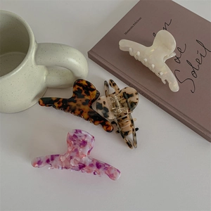 Elegant large acetate hair claws in four marble patterns for stylish women hair styling