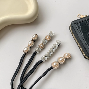 Elegant hair bun maker set with pearls and flower motifs on white textured background