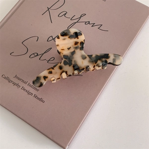 Close-up of tortoise shell pattern acetate hair claw clip with glossy finish and strong grip