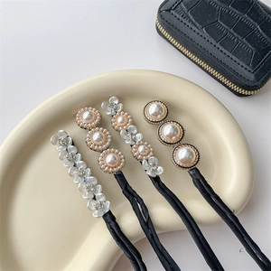 Elegant floral pearl hair bun maker set with rhinestones on a wavy display tray