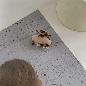 Close-up of tortoise shell pattern acetate hair claw clip with glossy finish and minimalist design