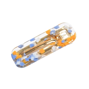 Molletta per capelli colorata in acetato con scaglie arancioni e blu su sfondo bianco