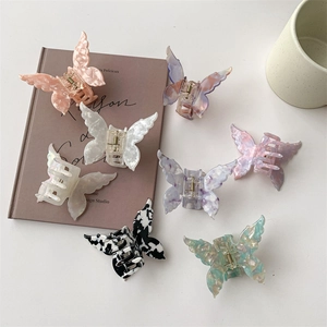 Elegant French butterfly hair claws in acetate with marble and iridescent patterns