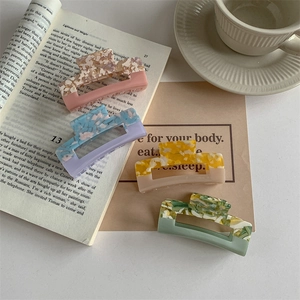 Set of four colorful acetate hair claws in pastel marble textures for women