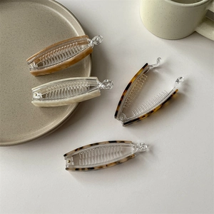 Lot de quatre barrettes banane en acétate avec motifs écaille de tortue et marbre