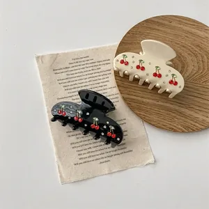 Vintage cherry hair claw clips in black and cream with sparkling rhinestones decoration