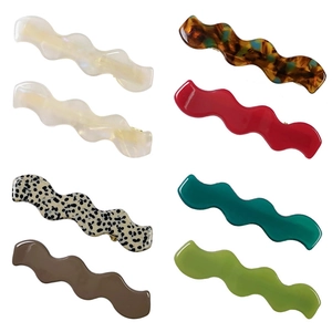 Set of wavy wave hair clips in seven assorted colors and marble textures on white background