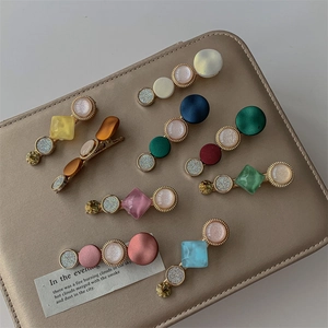 9-piece geometric pearl and resin hair clip set in various vintage colors and textures