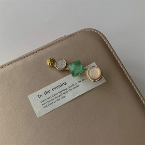 Detailed macro view of geometric hair clip with pearl and marble texture on leather