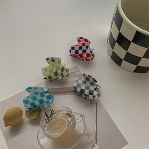 Chic checkered mini hair claws in vibrant colors on a fresh white aesthetic background