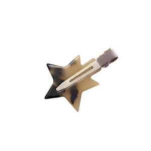 Star shaped acetate hair clip with leopard print pattern and silver metal base on white background