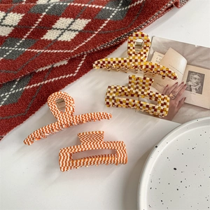 French vintage acetate hair claws in orange and brown checkerboard and striped patterns