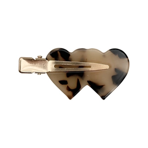 Tortoiseshell heart acetate hair clip with gold metal duckbill grip on white background