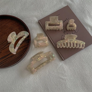 Elegant pearlescent white acetate hair claw clips set in various sizes and shapes