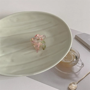 Detailed view of a small floral acetate hair claw clip with pink and green resin gradients