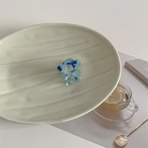 Detail of blue and white marble acetate flower hair claw clip on a stylish display tray
