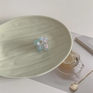 Detailed macro view of acetate floral hair claw clips in pastel macaron colors