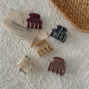 Five-piece acetate hair claw set in matte and marble finishes with handmade text
